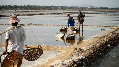 KAMPOT, CAMBODIA - 12th MARCH, 2017: Local people working in the salt fields in the Kampot, Cambodia, Asia.