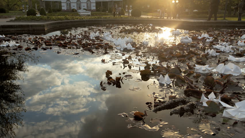 Timelapse Fountain with reflections of clouds and blue sky at daytime
