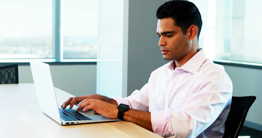 Male executive working on laptop at desk in office | Shutterstock HD Video #27929563