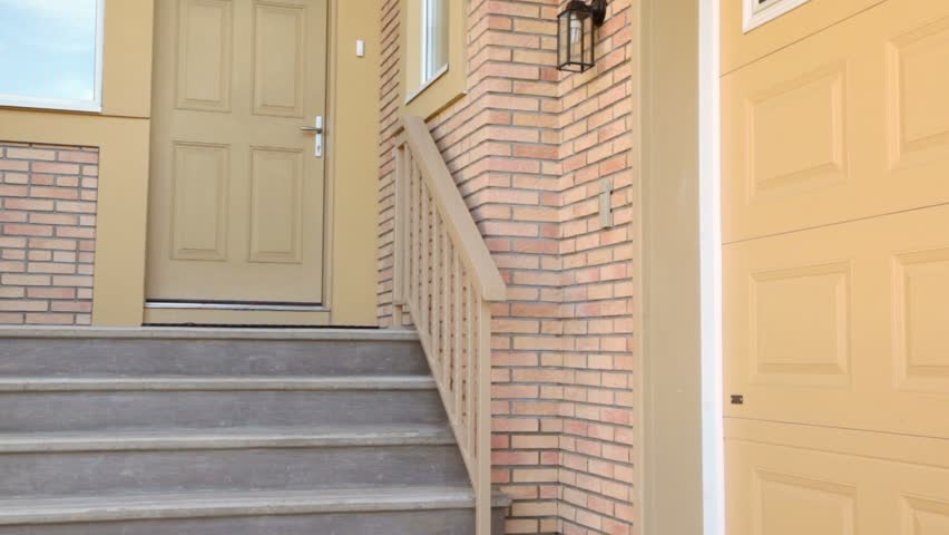 Little girl comes to entrance of cottage and rings at door bell, then walks away