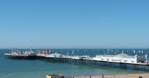 Time lapse view of many sailing boats in a race (regatta) around Brighton pier