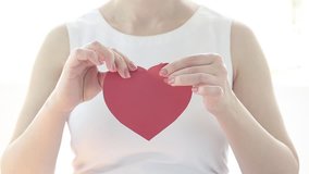A girl breaks a paper heart - Powered by Shutterstock - Get 15% off with code: PIKWIZARD15
