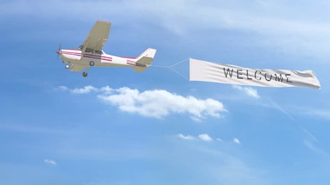 Small propeller airplane towing banner with WELCOME caption in the sky. 4K clip