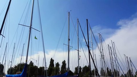 Low angle sailboat masts in the blue sky