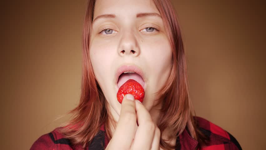 Cei joi eating. Woman eat Strawberry.