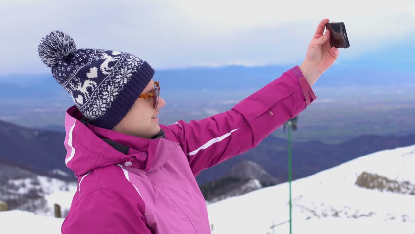 Girl taking a selfie in the mountains
