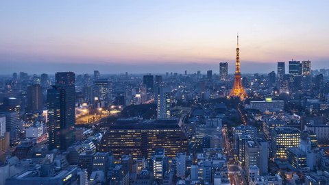 4k time lapse of day to night sunset scene at Tokyo city skyline with Tokyo Tower. Pan left