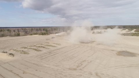 Tanks travel through the sand and shoot