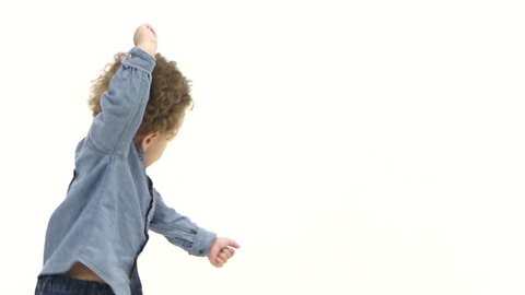 Kid african american dances to cheerful music. White background. Slow motion