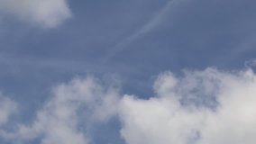 Slow white clouds on blue sky background. Time lapse of fluffy clouds on sky background
