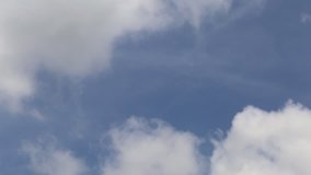 Slow white clouds on blue sky background. Time lapse of fluffy clouds on sky background
