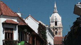 Shot of roofs in historic town with spire of Cathedral Basilica of Saint Catherine of Alexandria in Cartagena, Columbia