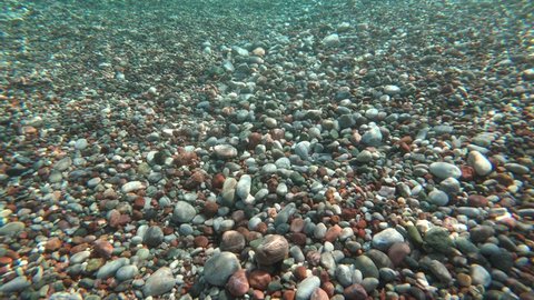 4K, Holiday beach shots, ocean and sea views. The camera goes underwater. Pure and blue water. Shale and coral reefs are visible. wide angle, closeup