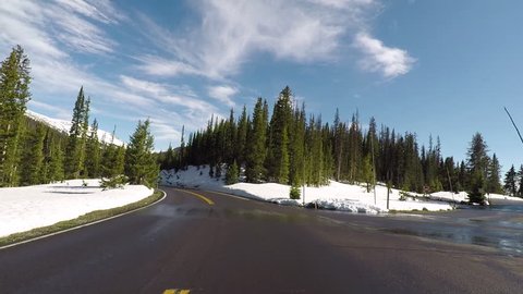 ESTES PARK, COLORADO - 1 JUN 2017: Rocky Mountain National Park spring snow drive POV. Northwest of Denver on the Continental Divide. Mountains, alpine lakes, tundra, forests and wildlife.
