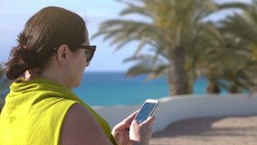 High quality video of woman surfing the net on the vacations in 4k