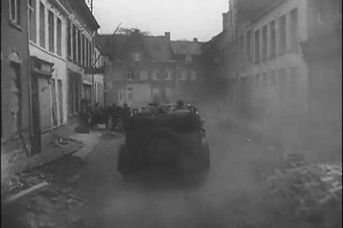 1940s: Nazis drive through ruins in war-torn France in 1940.