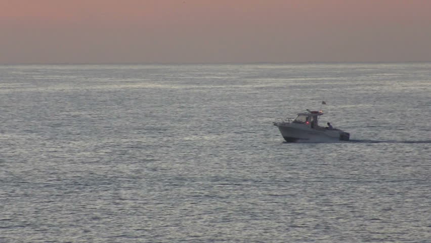 Motor boat sailing on the sea at dawn