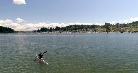 Man in Kayak Paddles Through Gig Harbor, Washington USA