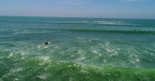 Surfers And Pelicans in California 4k 24fps
