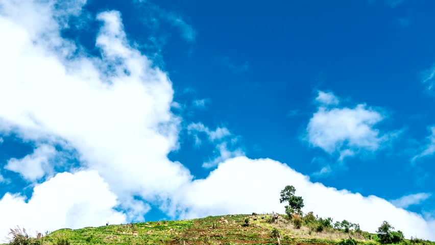 4K Time lapse of beautiful landscape and moving clouds over mountain. Camera zoom out