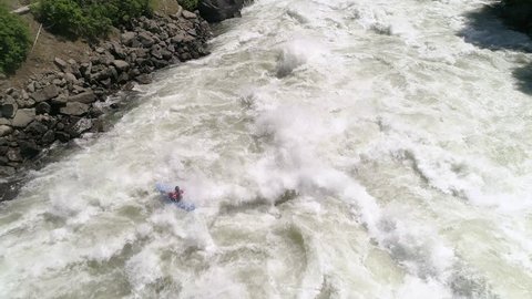 Aerial of Extreme White Water Kayaking Following Paddler Down Raging River with Violent Rapids Video de stock