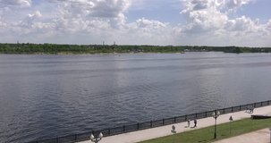 Video footage view of Volga River, historical embankment, promenade of Yaroslavl city on sunny day with tourists, ships passing by in Yaroslavl Oblast area, 260 km north-east of Moscow, central Russia