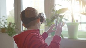 High quality video of boy wearing virtual reality glasses and playing games in 4k in slow motion 60fps
