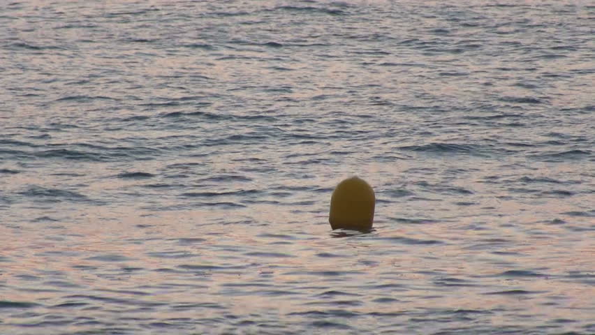 Yellow Buoy bobs on the waves, closeup