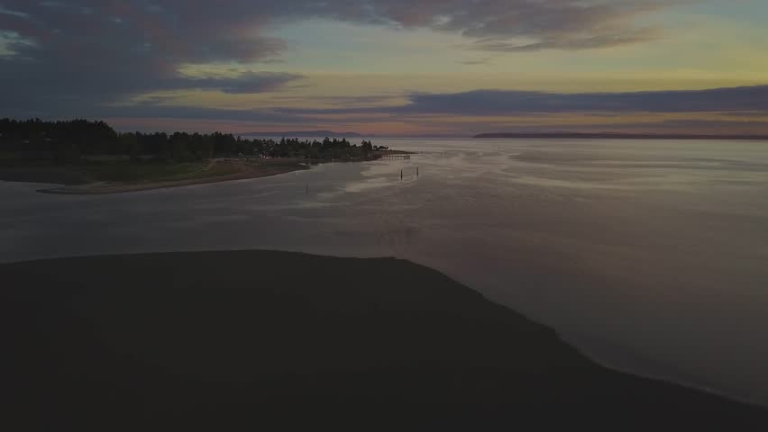 Aerial view of a beach during a cloudy sunset with a colorful sky. Taken in White Rock, Greater Vancouver, British Columbia, Canada.
