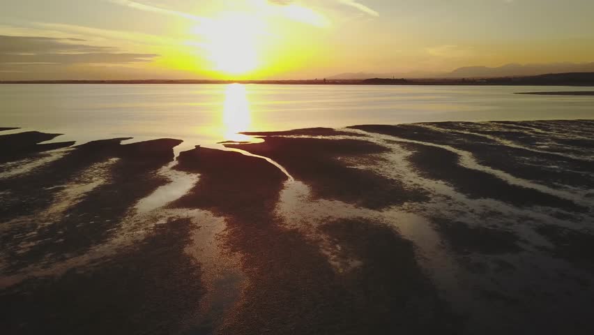 Aerial view of a beach during a cloudy sunset with a colorful sky. Taken in White Rock, Greater Vancouver, British Columbia, Canada.