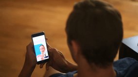 Man holds a video chat with a woman on a smartphone