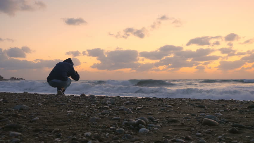 The man photographs the sea sunset