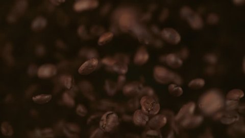 Coffee beans fly after being exploded. Shot with high speed camera, phantom flex 4K. Slow Motion.