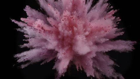 Colorful powder/particles fly after being exploded against black background. Shot with high speed camera, phantom flex 4K. Slow Motion.
