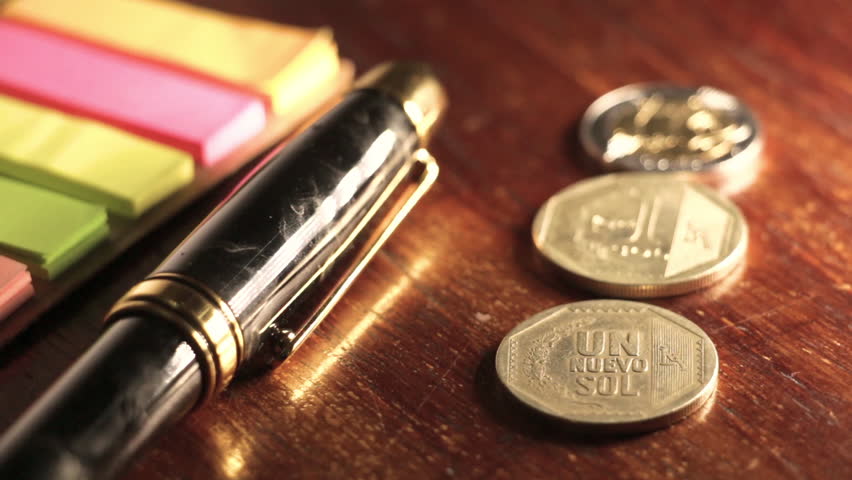 Putting pen next to coins Royalty-Free Stock Footage #28042591