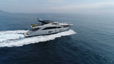 Aerial lateral view of a luxury yacht navigating at open sea
