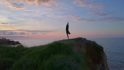 Peaceful health girl Vrksasana yoga meditate sunrise coast namaste drone footage