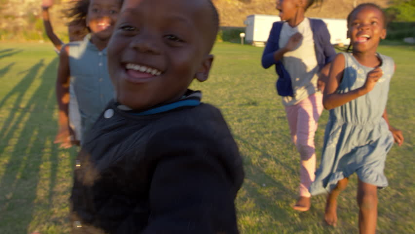 Elementary school kids running and waving to camera outdoors | Shutterstock HD Video #28048963