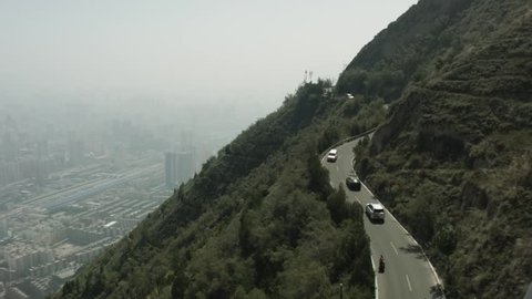 Traffic on the road to the Lanshan Mountain. Lanzhou, China.