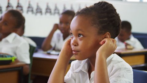Schoolgirl listening during a lesson at an elementary school