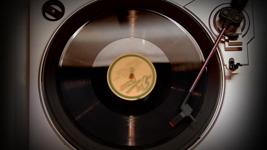 A bird's-eye view of a rotating record turntable.