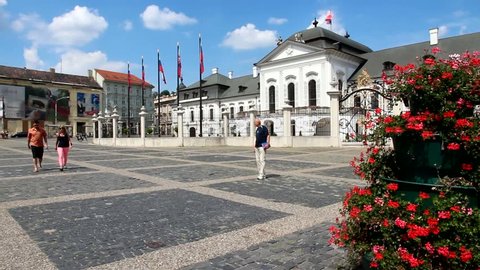 BRATISLAVA, SLOVAKIA - AUGUST 8: Tourists walk in front of Grassalkovich Palace (President's seat) on August 8, 2012 in Bratislava, Slovakia. Bratislava is largest and most visited city in Slovakia.