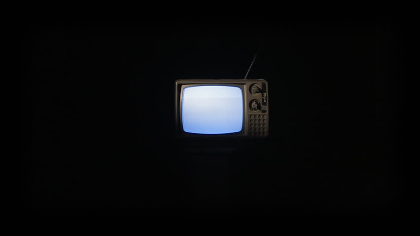A quick zoom into an old retro tv showing static.
