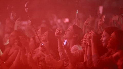 VINNITSA, UKRAINE - JUNE 2017: Music fans takes smartphone video records at party