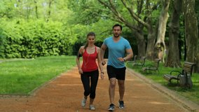 Young couple having morning jog, run. Man and woman catching breath, tired after running. close up. Slow motion - Powered by Shutterstock - Get 15% off with code: PIKWIZARD15