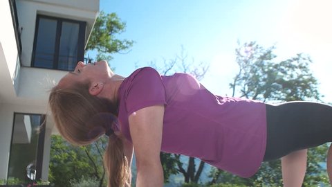 Fitness Woman Doing Stretching in front of mansion