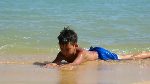 Young boy relaxing on the tropical beach