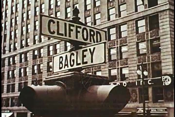 1960s: Various scenic shots of the Detroit cityscape, and a plaque dedicated Ford Motor cars in Detroit in the 1960s.