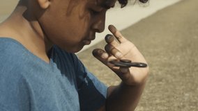 4K Close Up of Mixed Race Young Boy Spinning Toy on Thumb