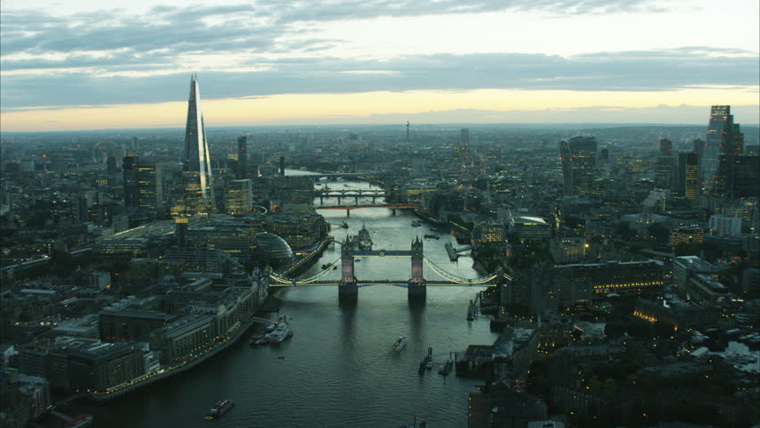 Aerial distant sunset view of the River Thames and city skyline of London UK RED DRAGON Royalty-Free Stock Footage #28093870